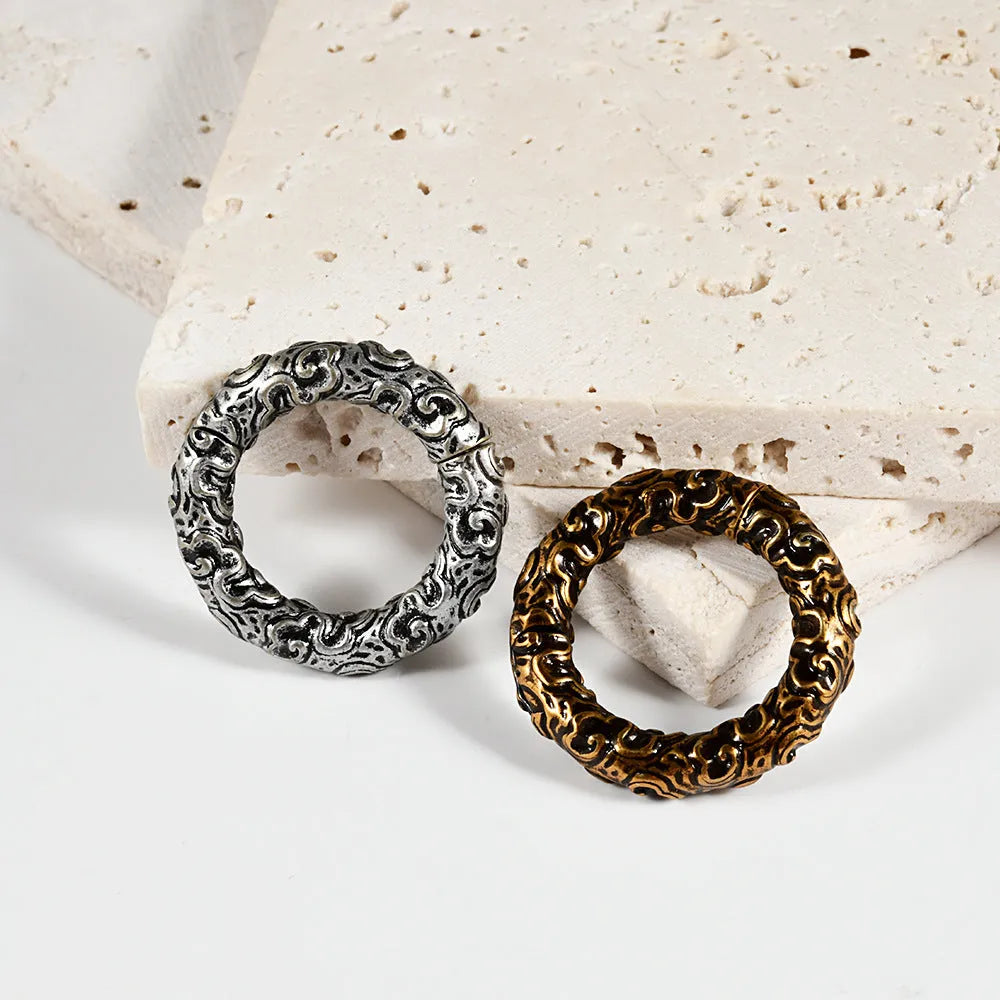 A pair of silver totem pattern fashion earrings made from stainless steel with an electroplated finish.