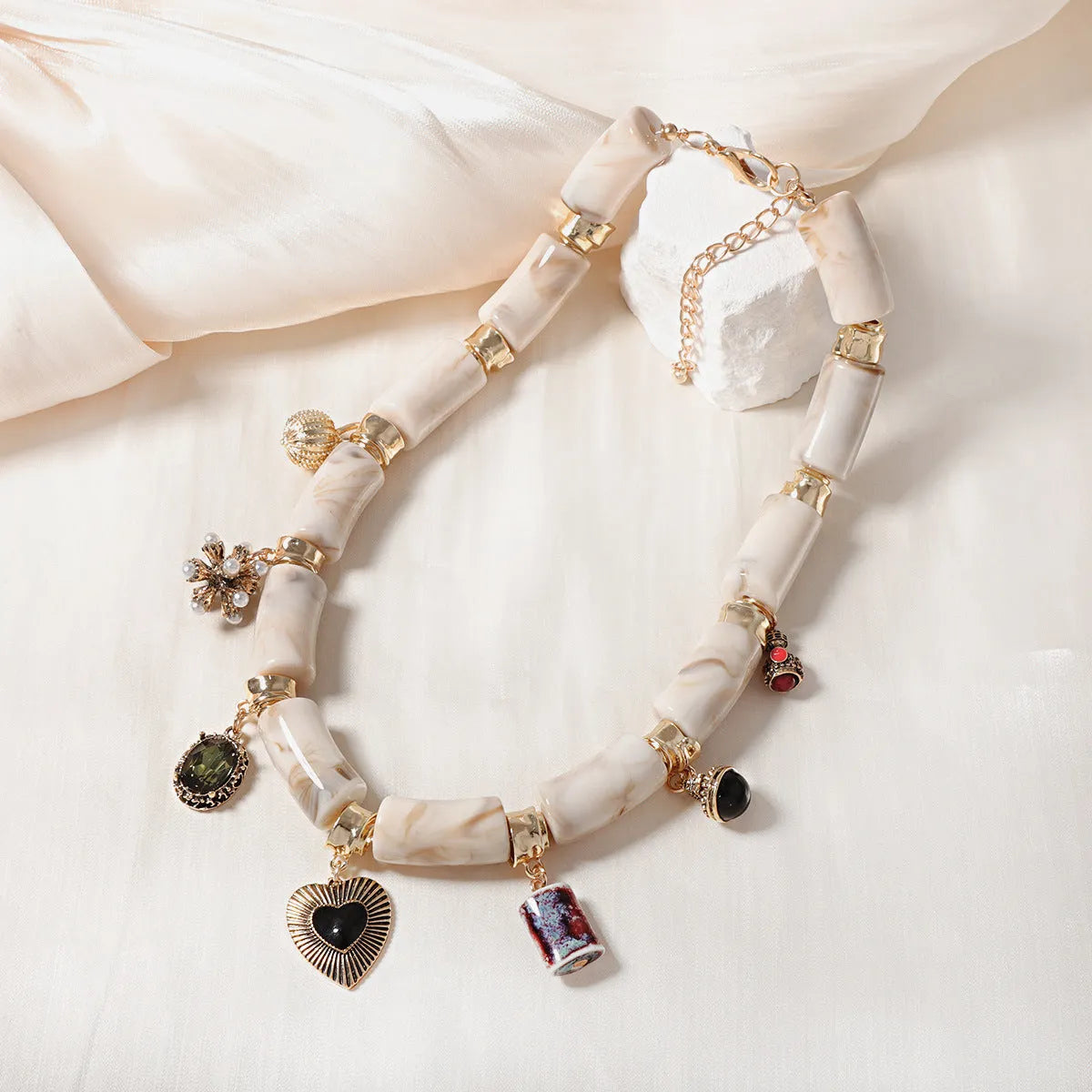Close-up of a heart-shaped bamboo pendant necklace with electroplated finish in a picture colour.