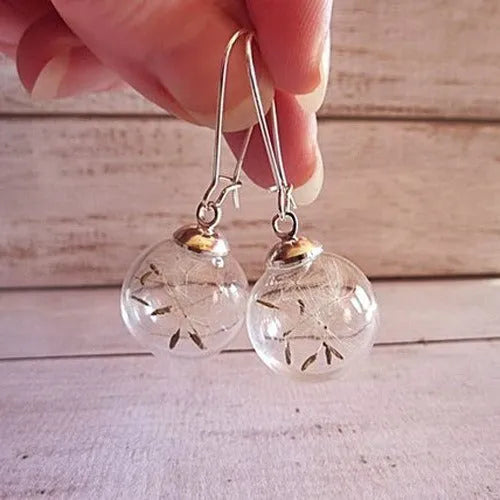 Transparent glass ball earrings with dandelion seed designs on French hooks in silver and bronze finishes