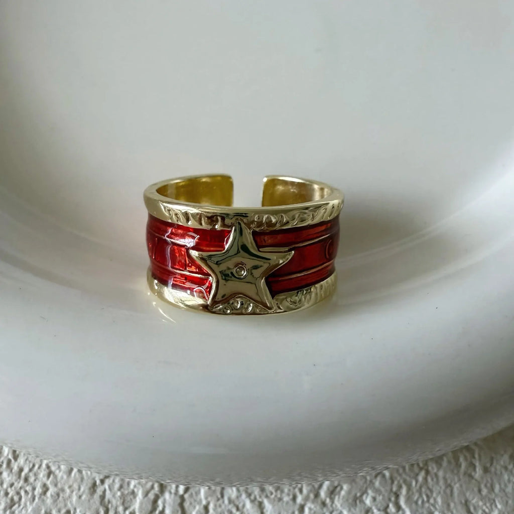 Adjustable distressed geometric ring with line design in electroplated black, blue, or red.