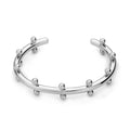 Stainless steel C-shaped charm with textured rivet bean beads on a round alloy bracelet.