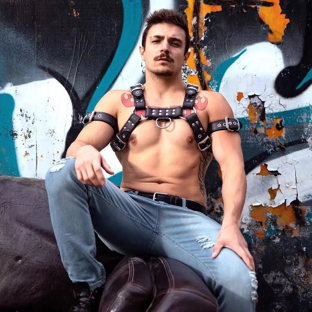 Men's black leather chest strap with metal buckles and rivets