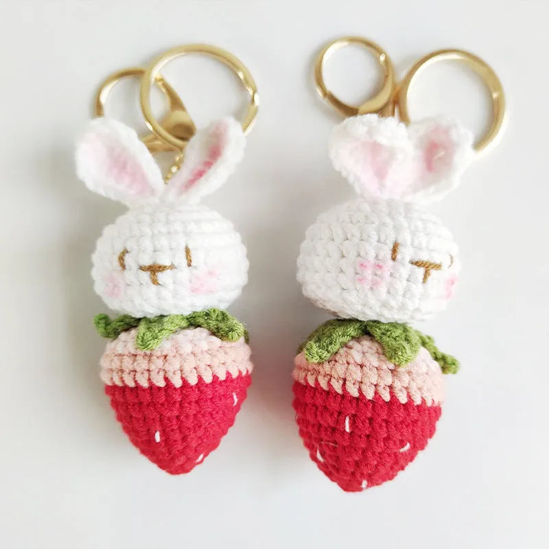 White hand-woven wire rabbit pendant with cartoon strawberry pattern and key attachment