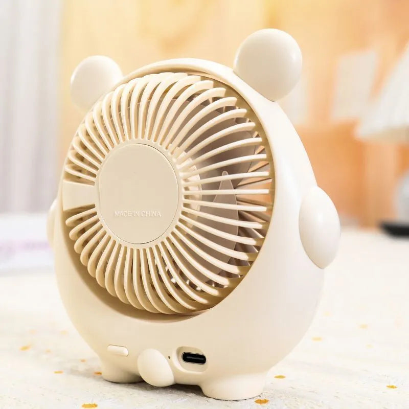 A Bear Brown coloured desktop USB electric fan for dogs on a wooden table.