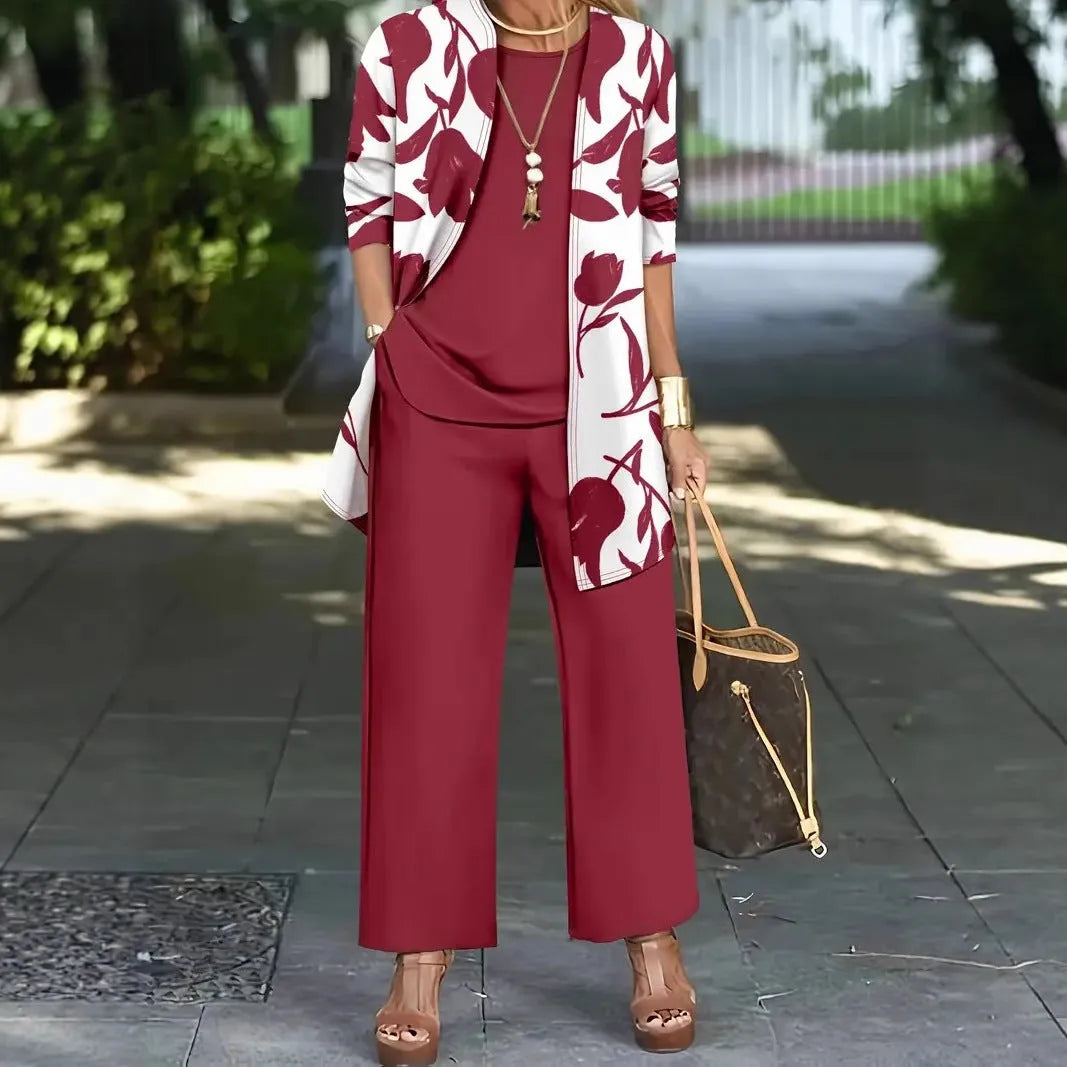 Women's blue printed three-piece casual suit with coat, vest, and trousers on a hanger.