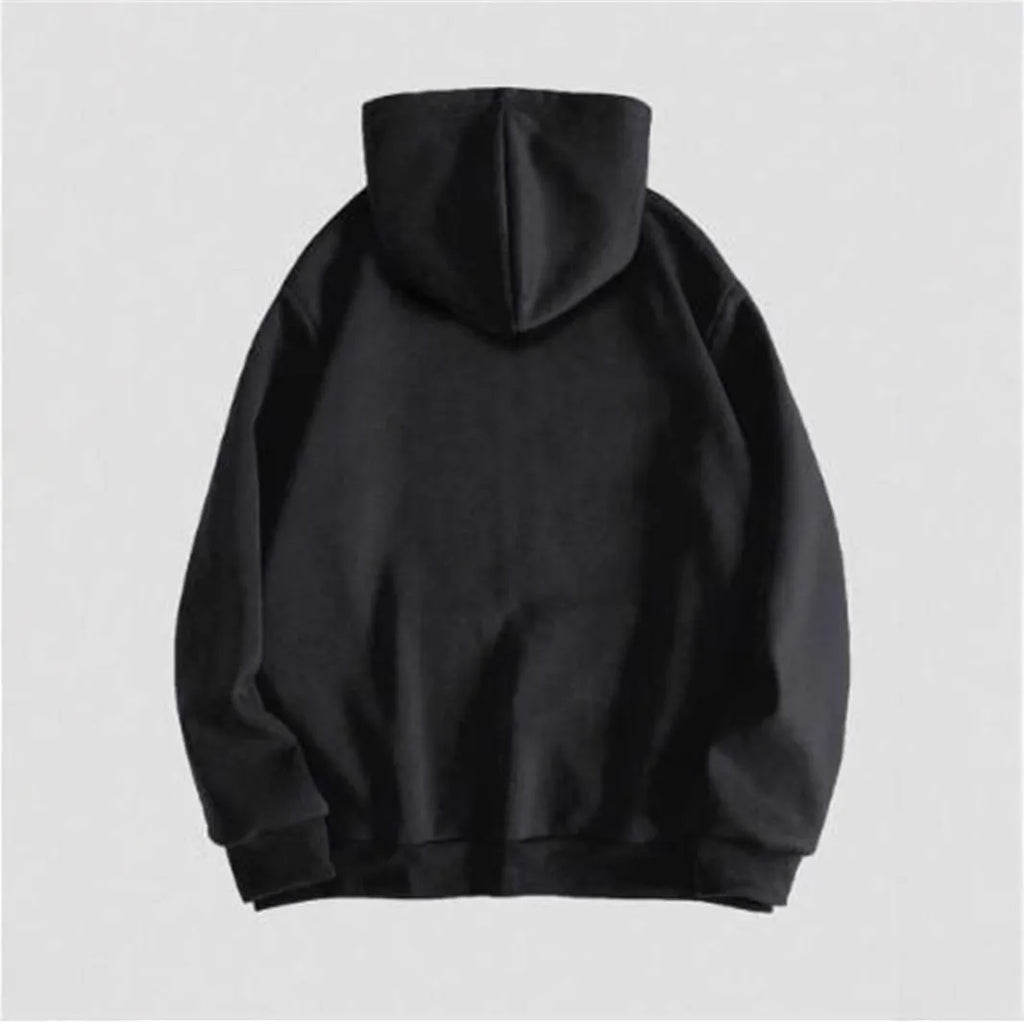 Man wearing a black hooded sweatshirt with a large green skull graphic print on the front.
