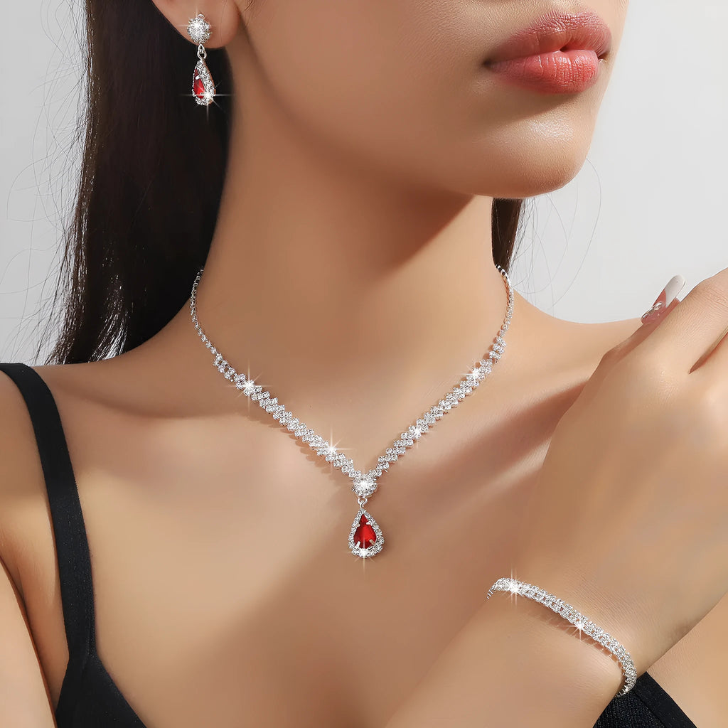 Claw chain necklace and matching earrings set with drop-shaped rhinestones in blue colour