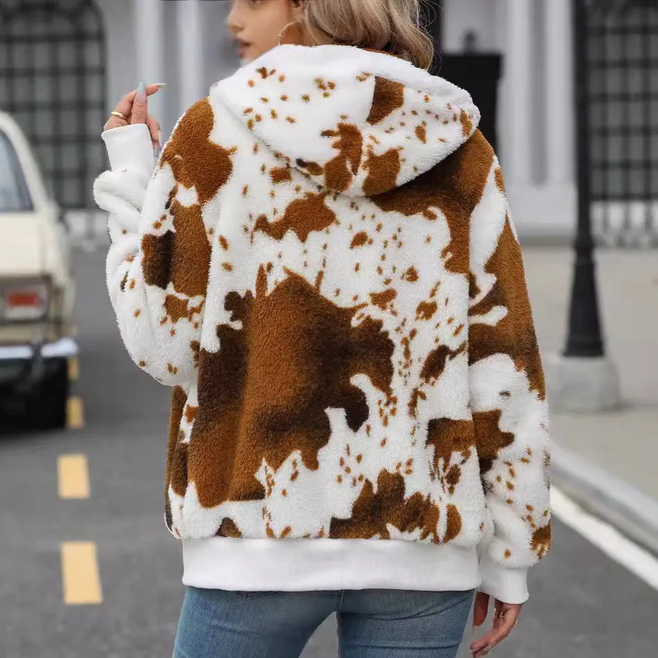Yellow brown cow animal print hooded cardigan jacket with zip front on a hanger