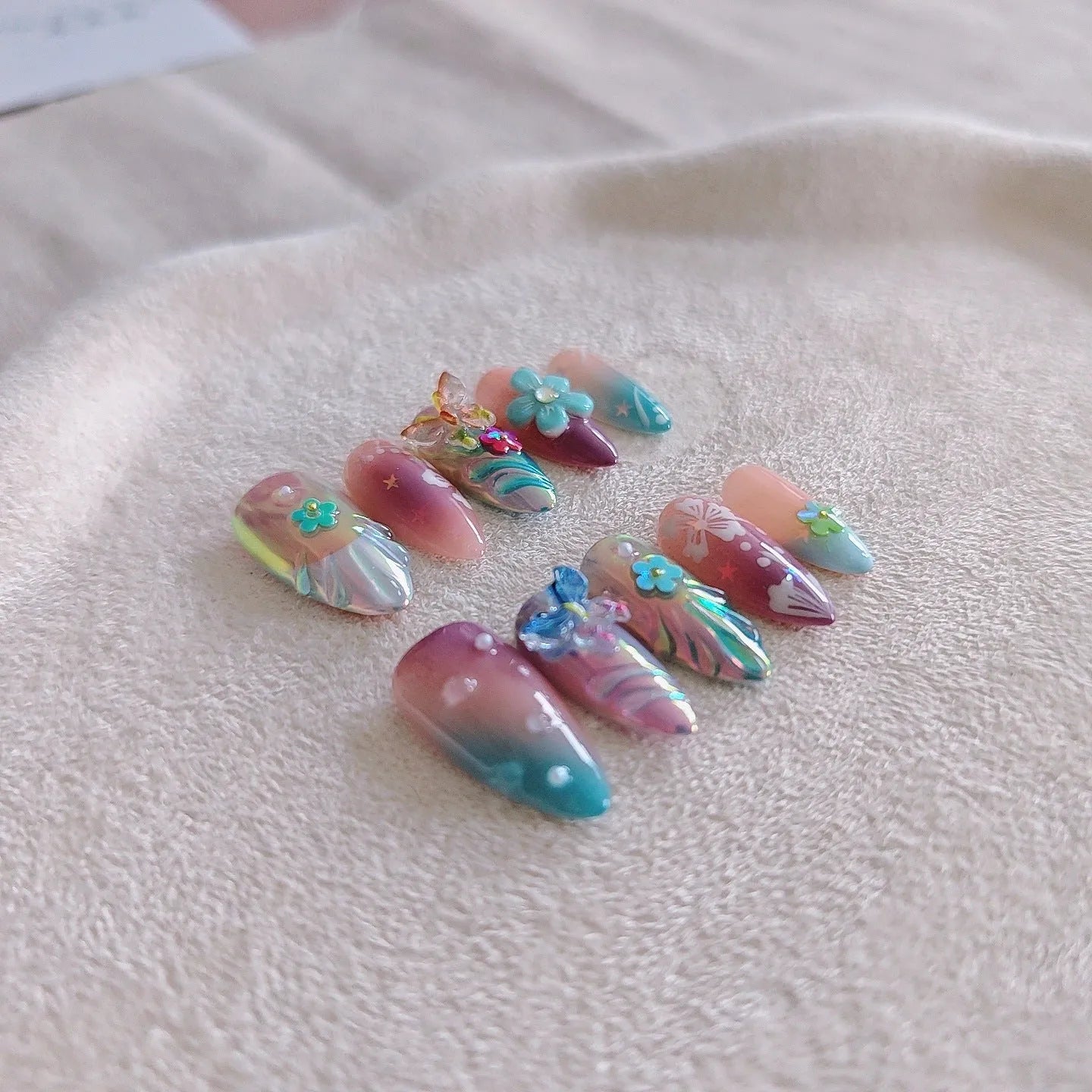 Handmade colourful floral and butterfly nail decorations set with embossed patterns in four sizes