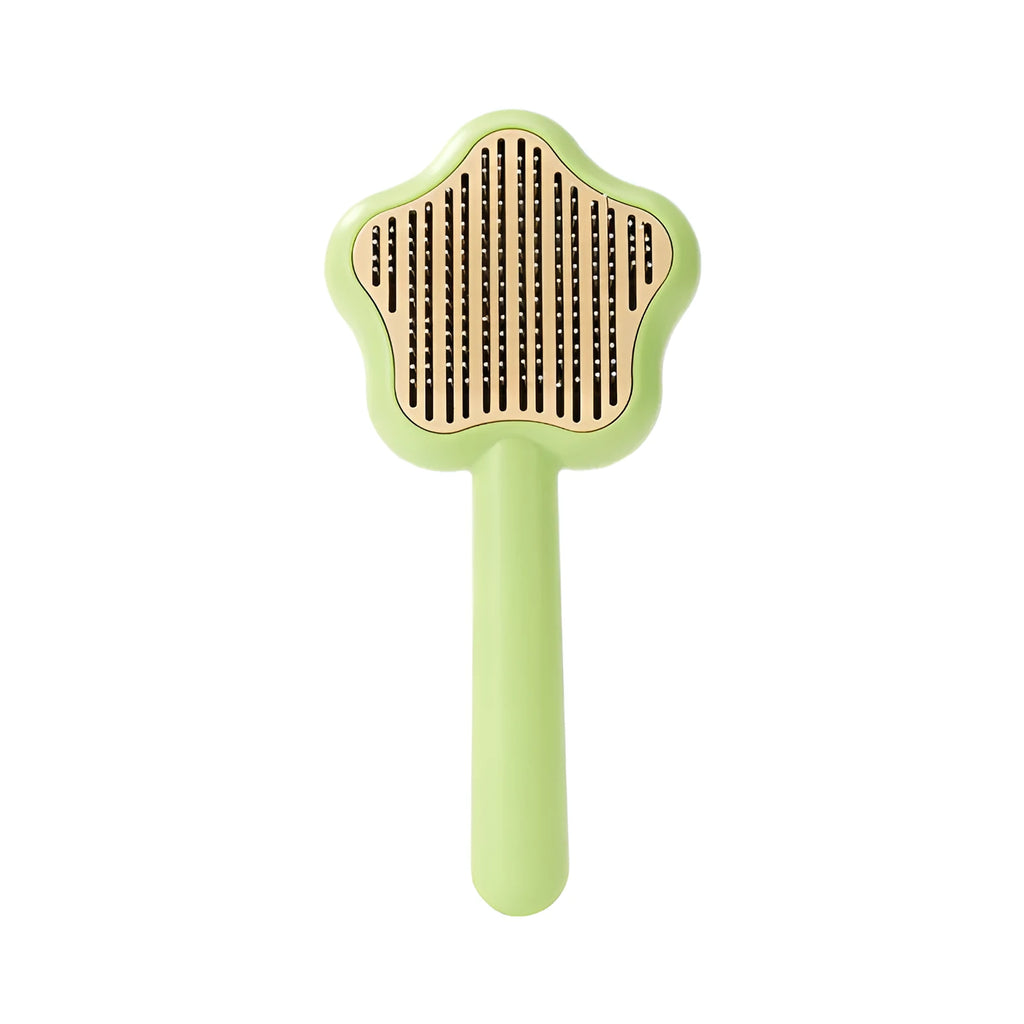 Green self-cleaning magic wand cat comb with stainless steel needle teeth on a white background.