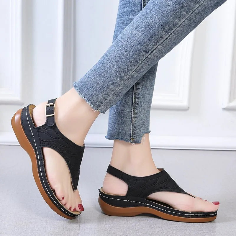 Women's casual wedge heel flip flop sandals with an adjustable buckle strap in solid colours.
