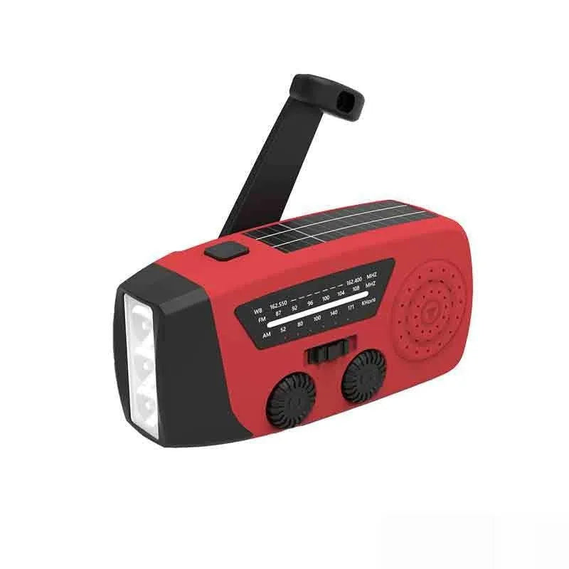 Red rechargeable emergency hand radio with torch, hand crank, and wrist strap on a white background.