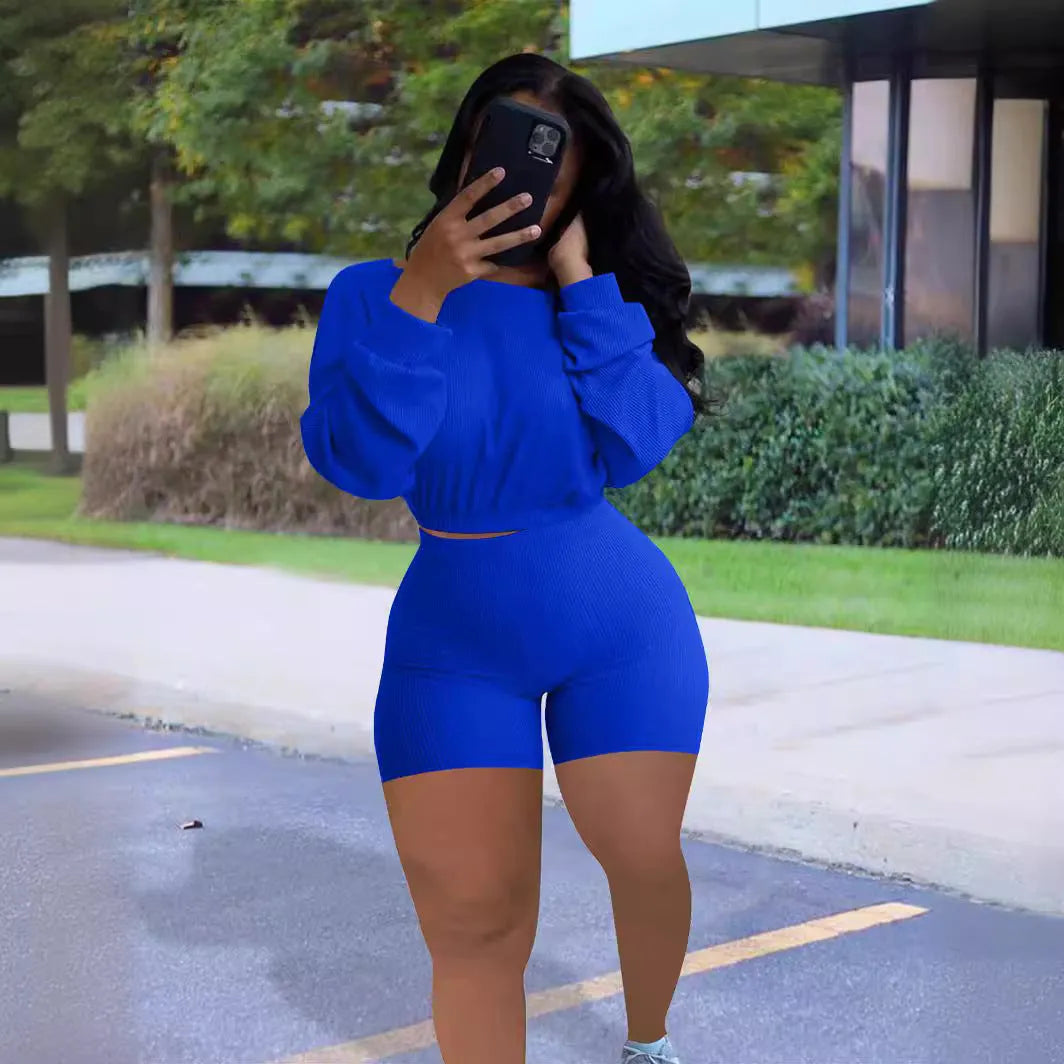 Women's off-the-shoulder long sleeve top with sunken stripe detail and matching solid colour shorts two-piece set.
