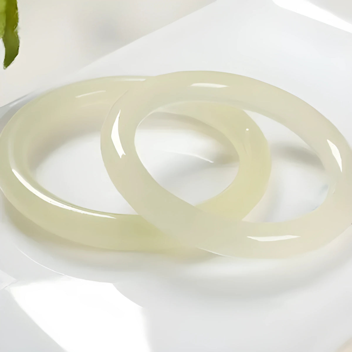 Round bar jade bracelet with geometric winding silk jade design, shown in a listed inner diameter size