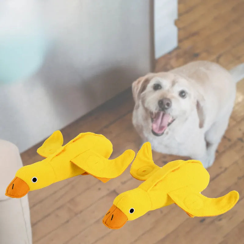 Yellow plush duck dog training toy with squeaker and treat dispensing features