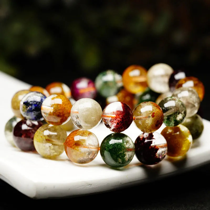 Natural crystal bracelet with 10mm beads showing ghost cornucopia ethnic design