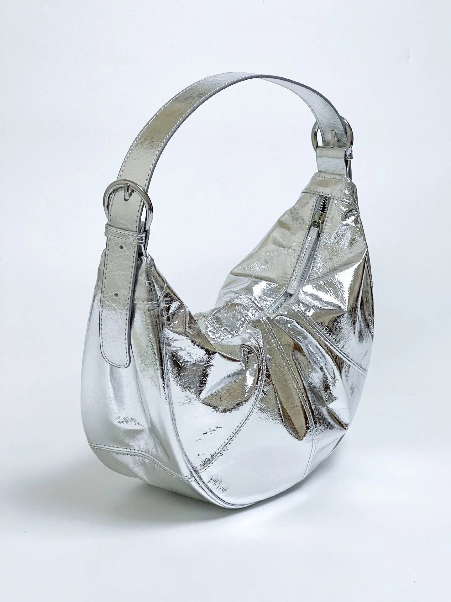 Women's soft cowhide leather dumpling-shaped shoulder bag in silver colour with double straps.