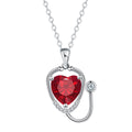 Women's fashion necklace with a copper wings cross stethoscope pendant featuring red diamond detail.