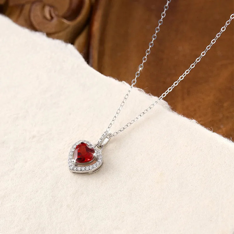 Sterling silver heart necklace with a choice of amethyst, citrine, topaz, olivine, or garnet gemstone on an adjustable chain.