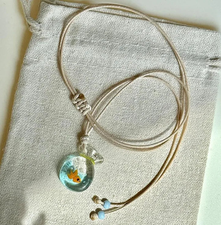 Women's necklace with a coloured glaze joker skirt pendant on a cotton and linen clavicle chain.