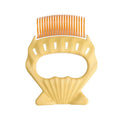 Shell-shaped pet grooming brush with bent wire bristles in green, orange or purple colours