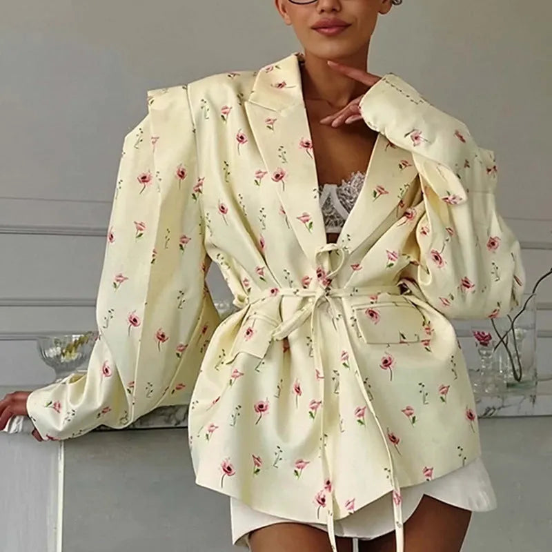 Women's suit jacket with lace-up detail at the collar and waist, shown in a floral print colour option.
