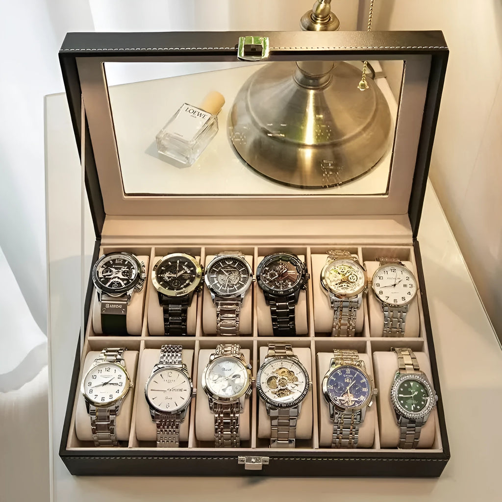 Grey leather watch storage box with transparent lid showing watch cushions inside.