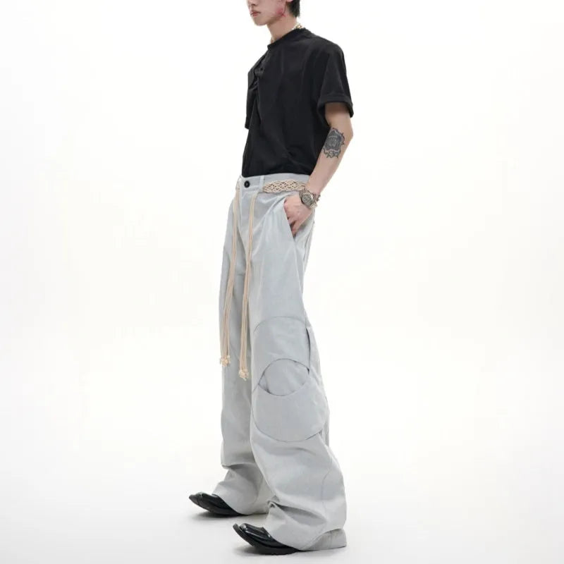 Men's dark blue loose fit straight leg jeans with zipper decoration and belt stitching detail.
