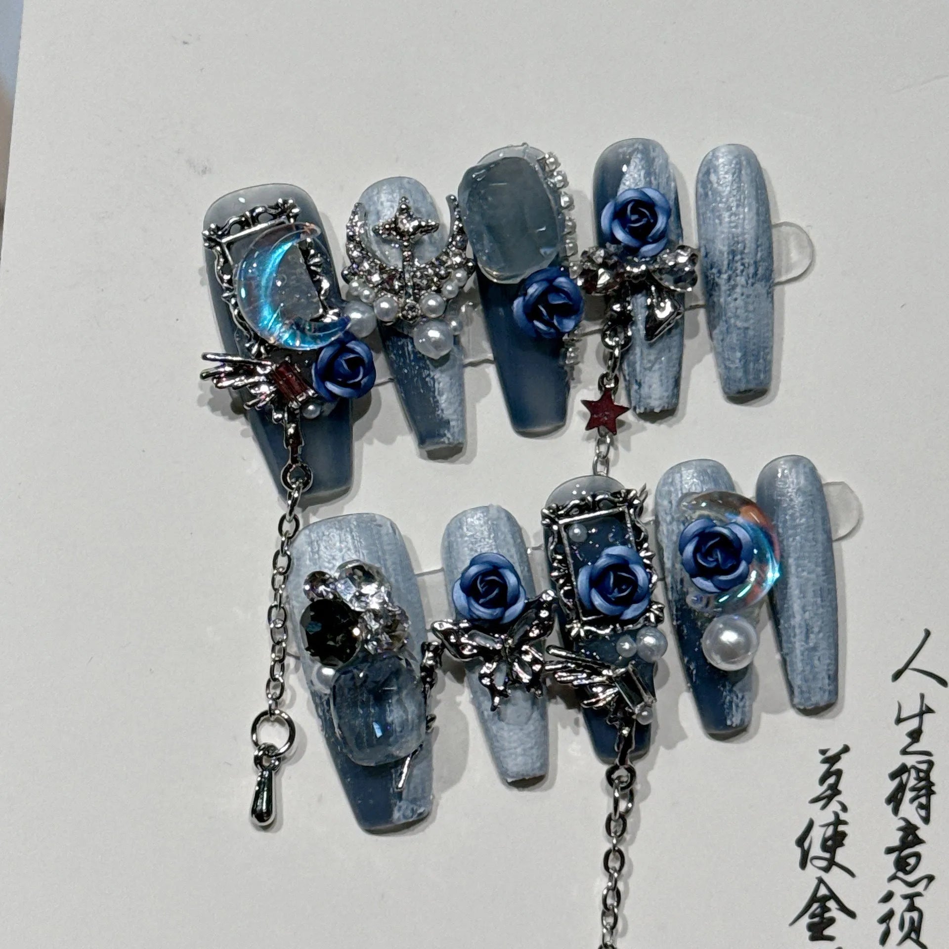 Blue night nail armour with ornate rose and tulip floral patterns in plastic evening manicure set