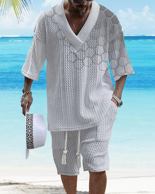Man wearing a printed drop-shoulder knitted short-sleeve top with matching shorts in a casual setting.