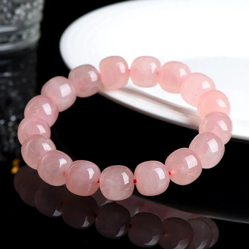 Natural pink crystal barrel bead bracelet with geometric design, 8-10mm beads