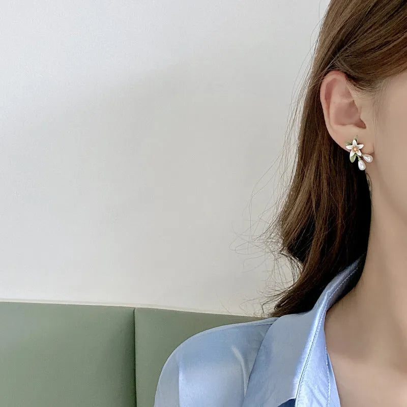 Women's alloy flower earrings showing sterling silver needle detailing on studs and contrast colours on clips