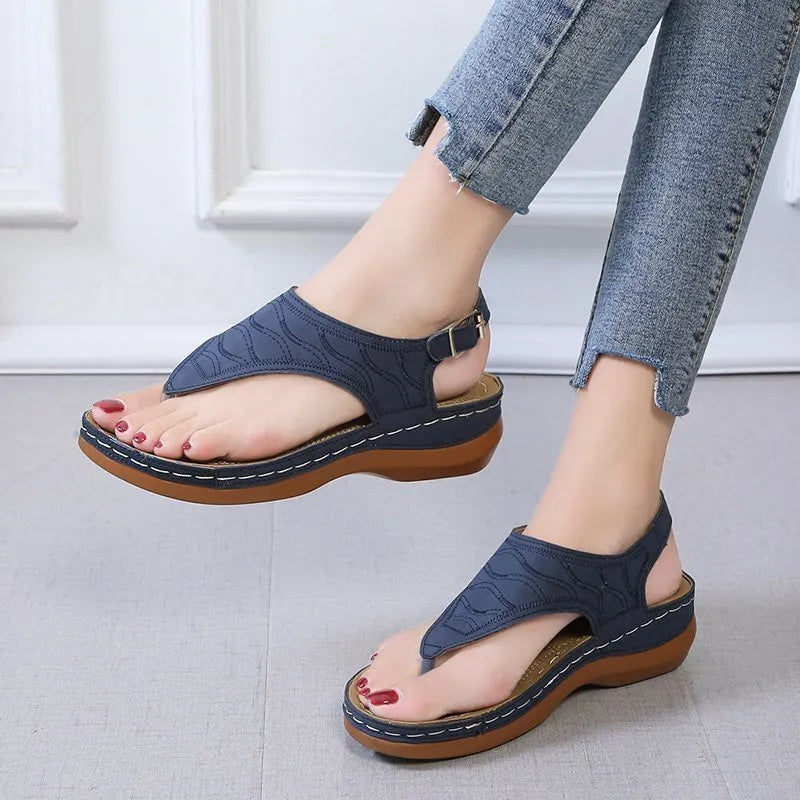 Women's casual wedge heel flip flop sandals with an adjustable buckle strap in solid colours.