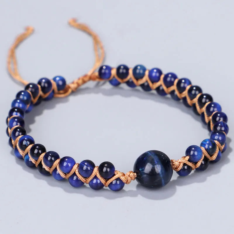 Close-up of a blue Tigereye hand-woven bracelet with a geometric pattern and pull closure.
