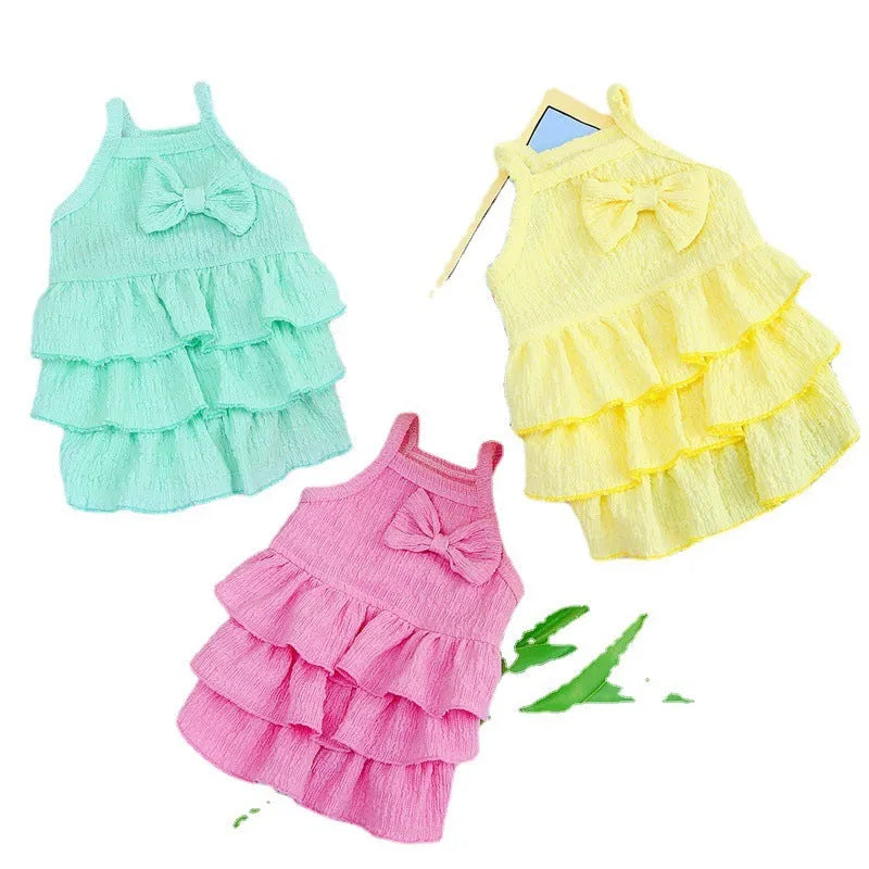 Small dog wearing polyester princess dress with layered candy skirt in teddy bichon style