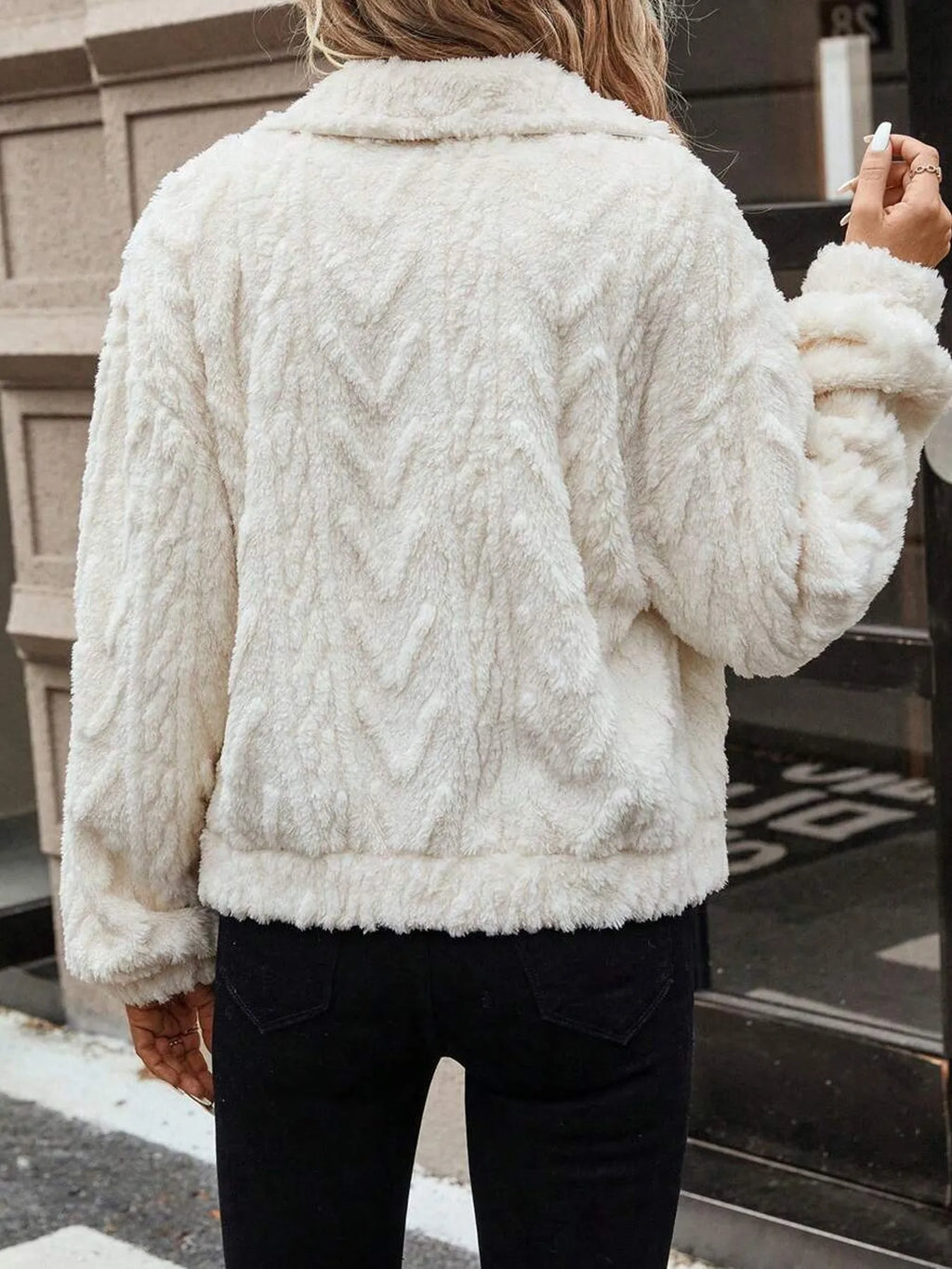 Ivory White women's plush button-front cardigan on a hanger