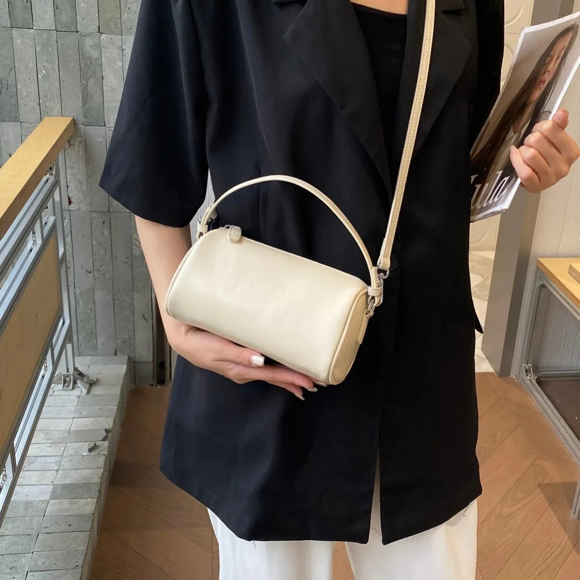Genuine vegetable tanned leather crossbody phone bag with cylindrical shape and single shoulder strap