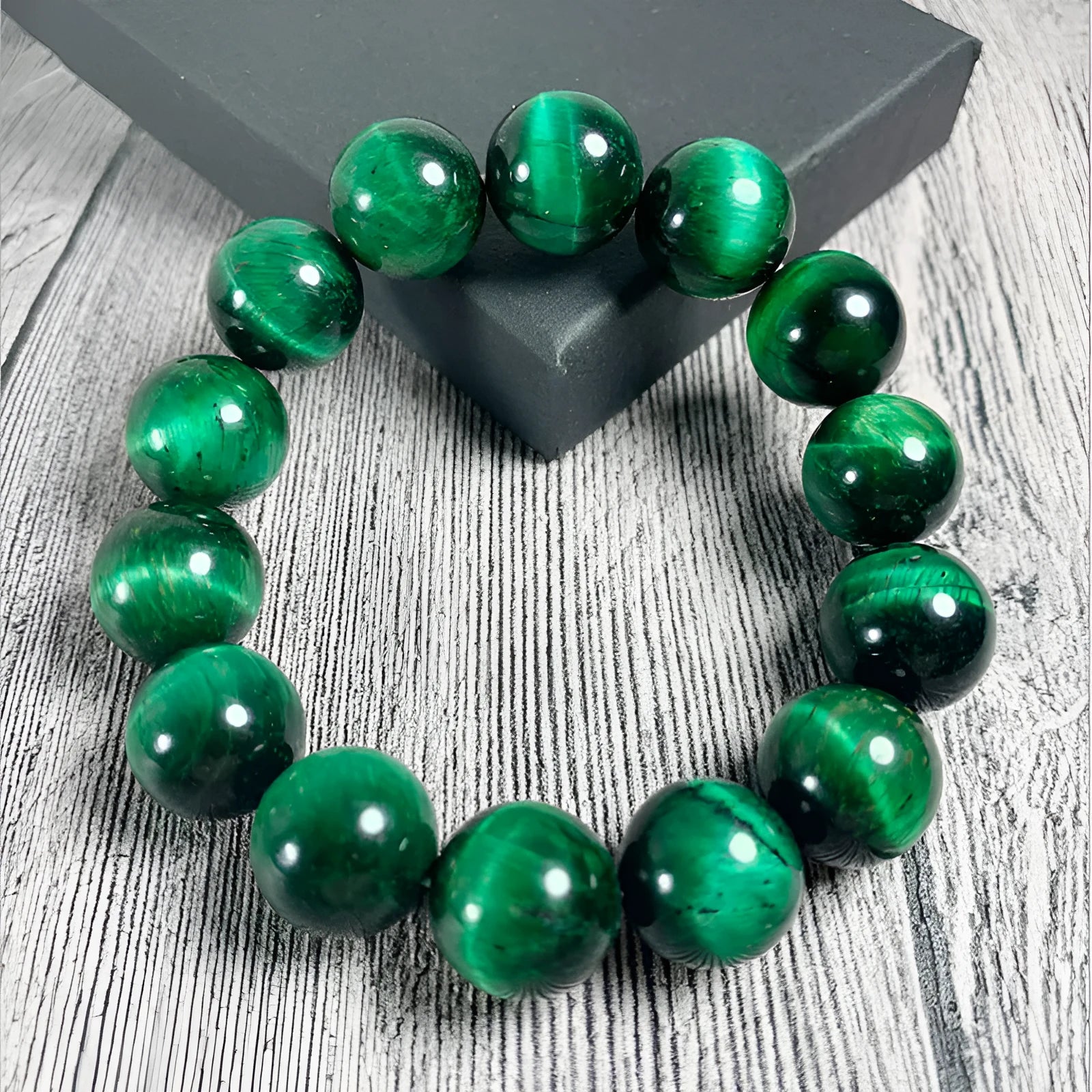 A polished green tiger eye stone bracelet with geometric beads, shown in various size options.