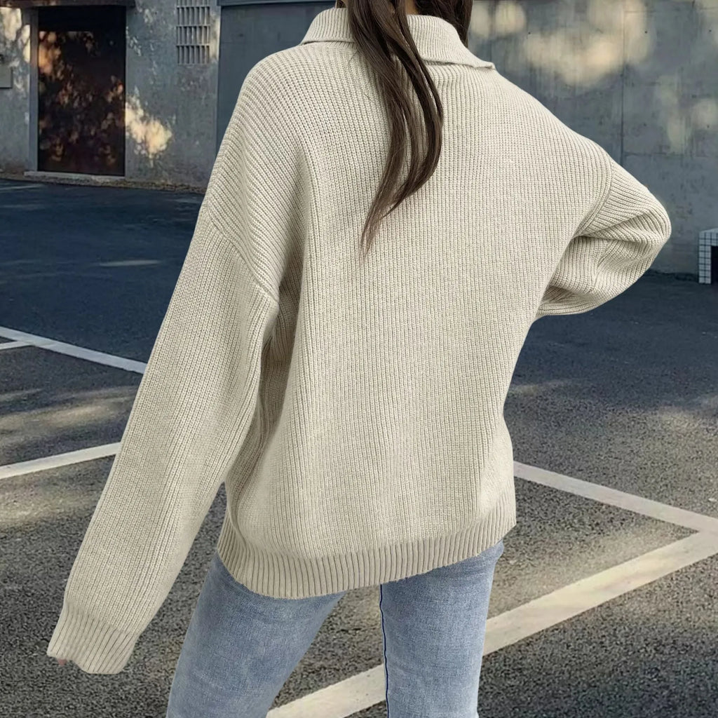 Woman wearing a light khaki alpaca wool pullover sweater with an oblique zipper and retro turtleneck.