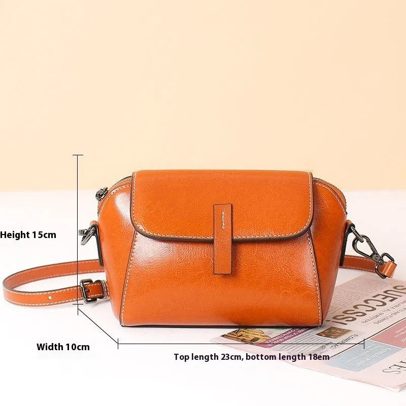 Women's brown oil wax cowhide shell-shaped crossbody messenger bag with visible stitching