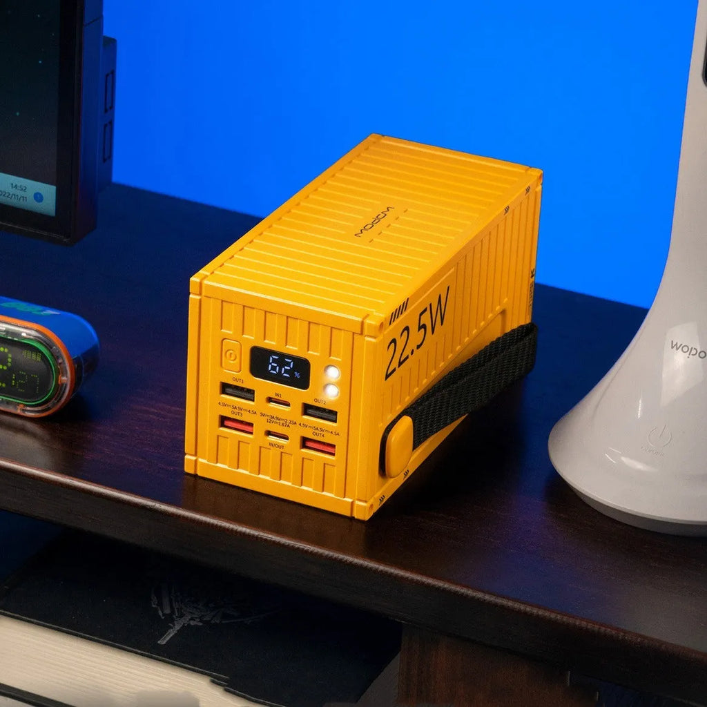 Large 50,000mAh power bank with digital screen and five USB output ports in yellow, black, or silver.