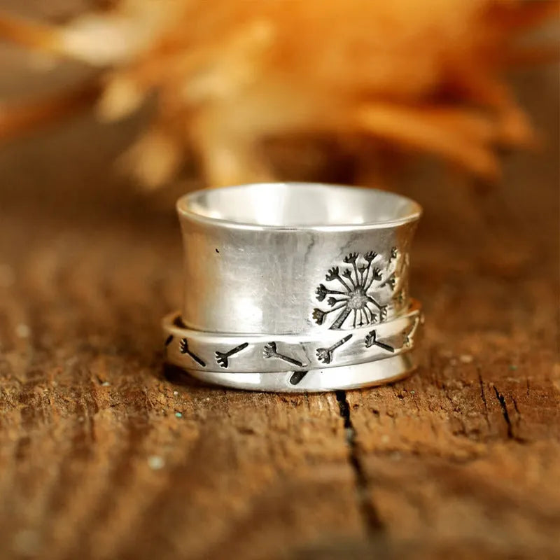 Silver rotatable flower ring showing floral detail and adjustable positioning
