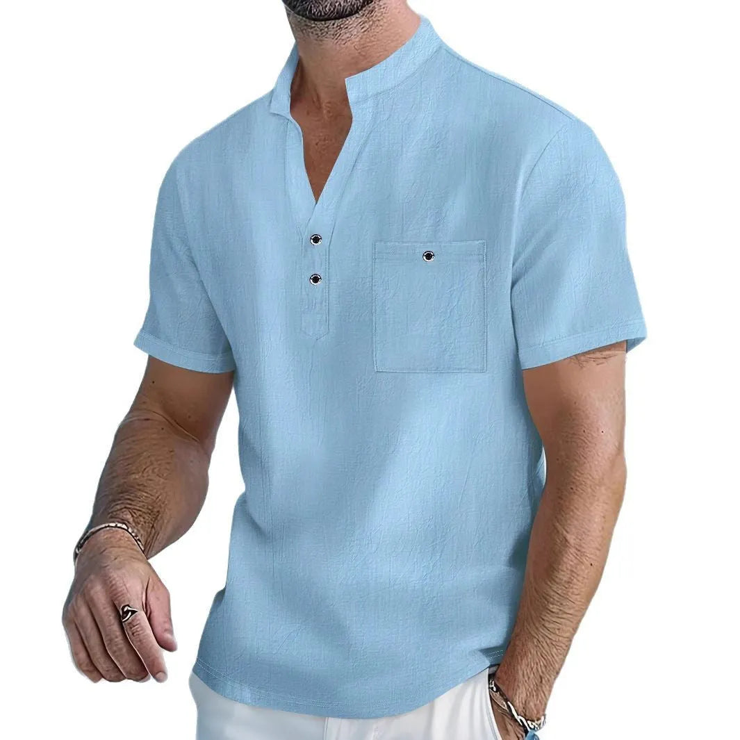 Man wearing a light blue stand collar linen short sleeve t-shirt with a loose fit.