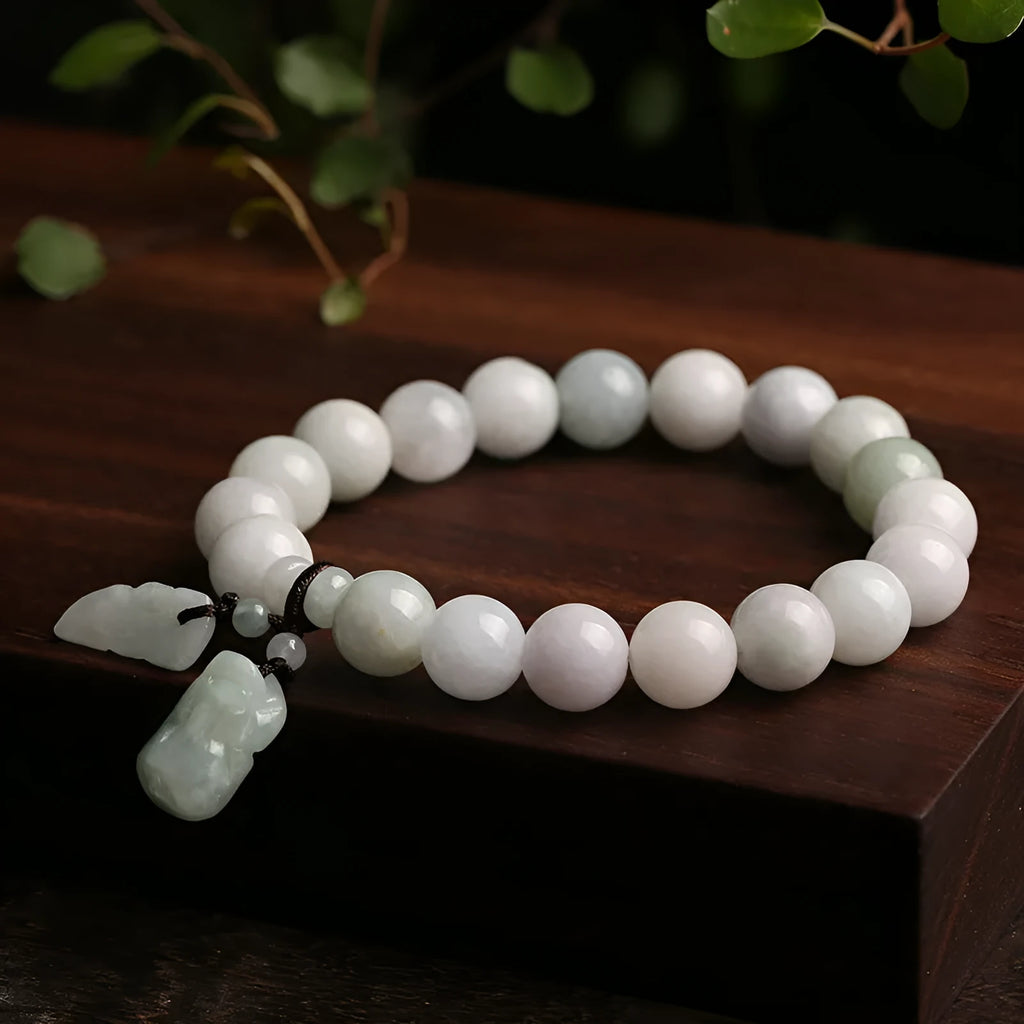 Natural emerald jade bracelet with hanging geometric beads and Buddhist elements