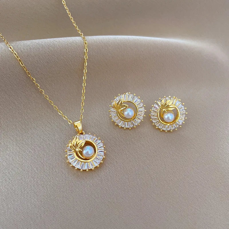 Titanium steel and gold plated geometric jewellery set showing necklace with copper pendant and matching stud earrings