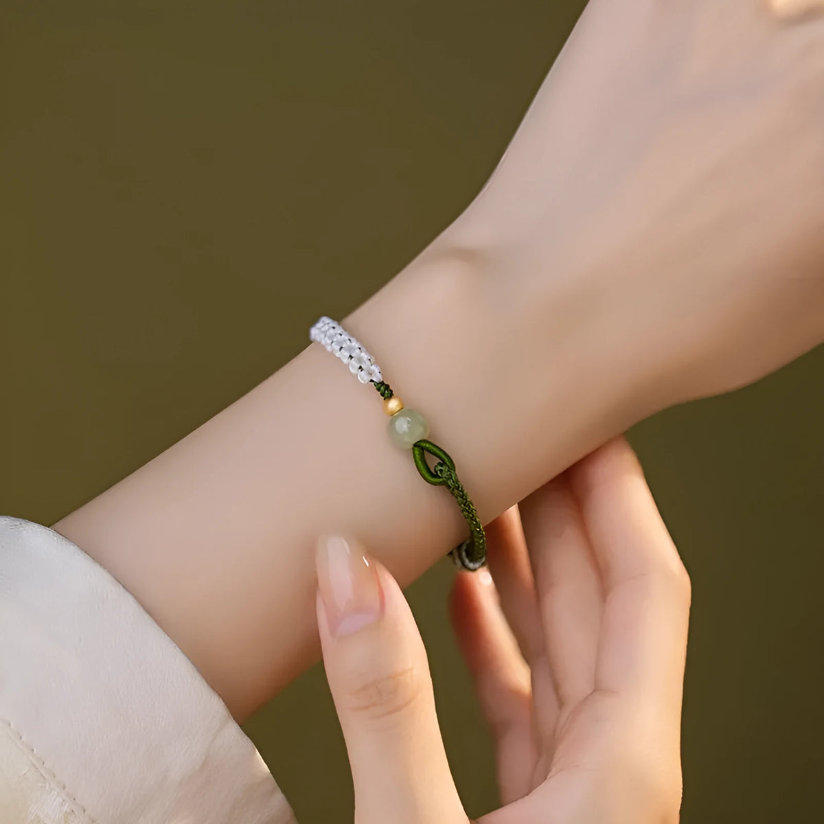Chinese national bracelet with colourful cord carrying strap and electroplated sterling silver fittings