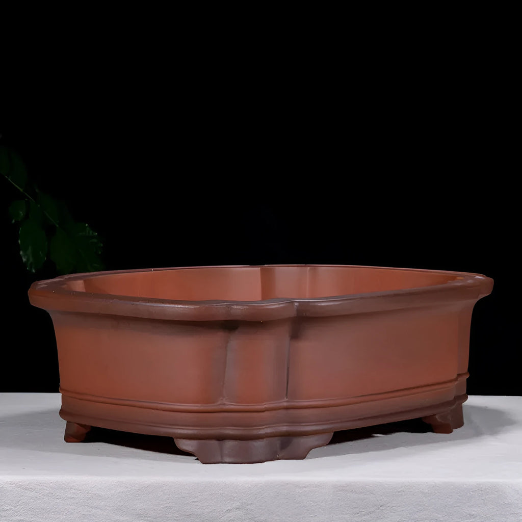 Large oval antique-finish purple clay flowerpot with carved crabapple tree design.