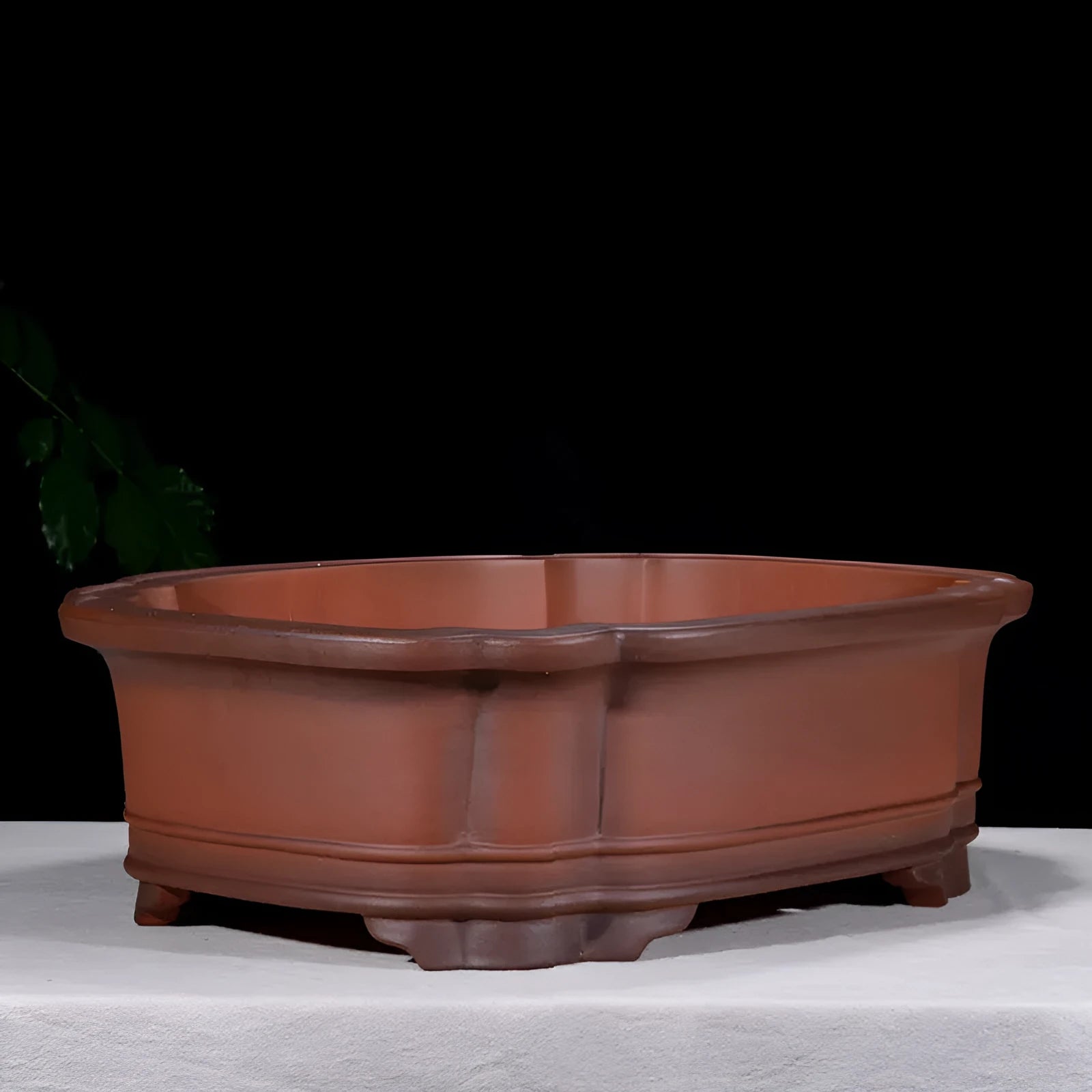 Large oval antique-finish purple clay flowerpot with carved crabapple tree design.