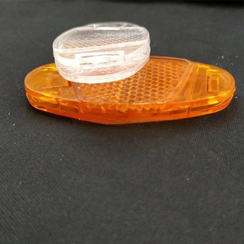 White and yellow bicycle spoke reflectors with plastic construction and night warning film