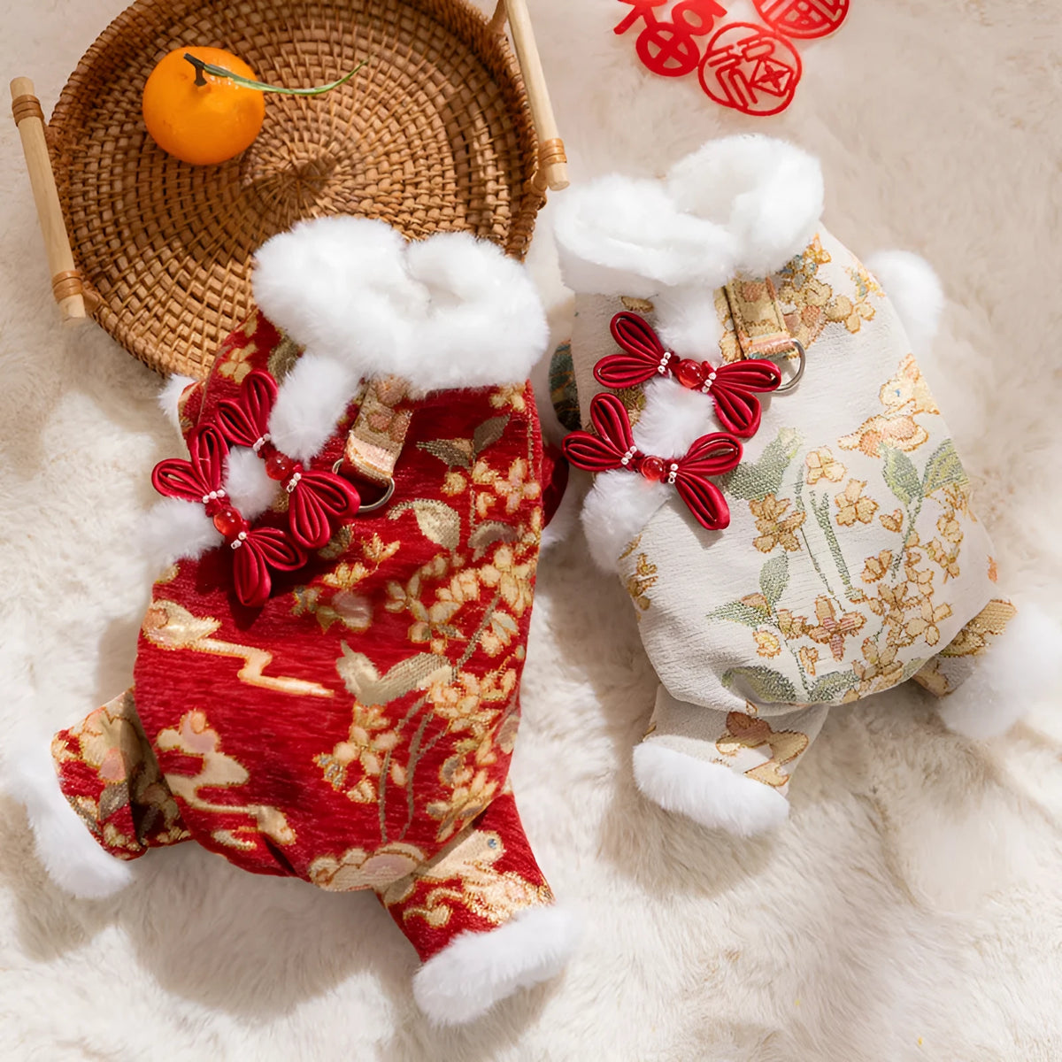 Lunar New Year brocade pet jumpsuit with faux fur trim, Chinese knot buttons and floral-gold motifs in red or beige.